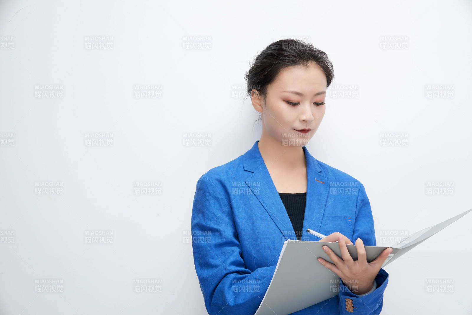 白色背景下拿著文件夾的美麗商務女士