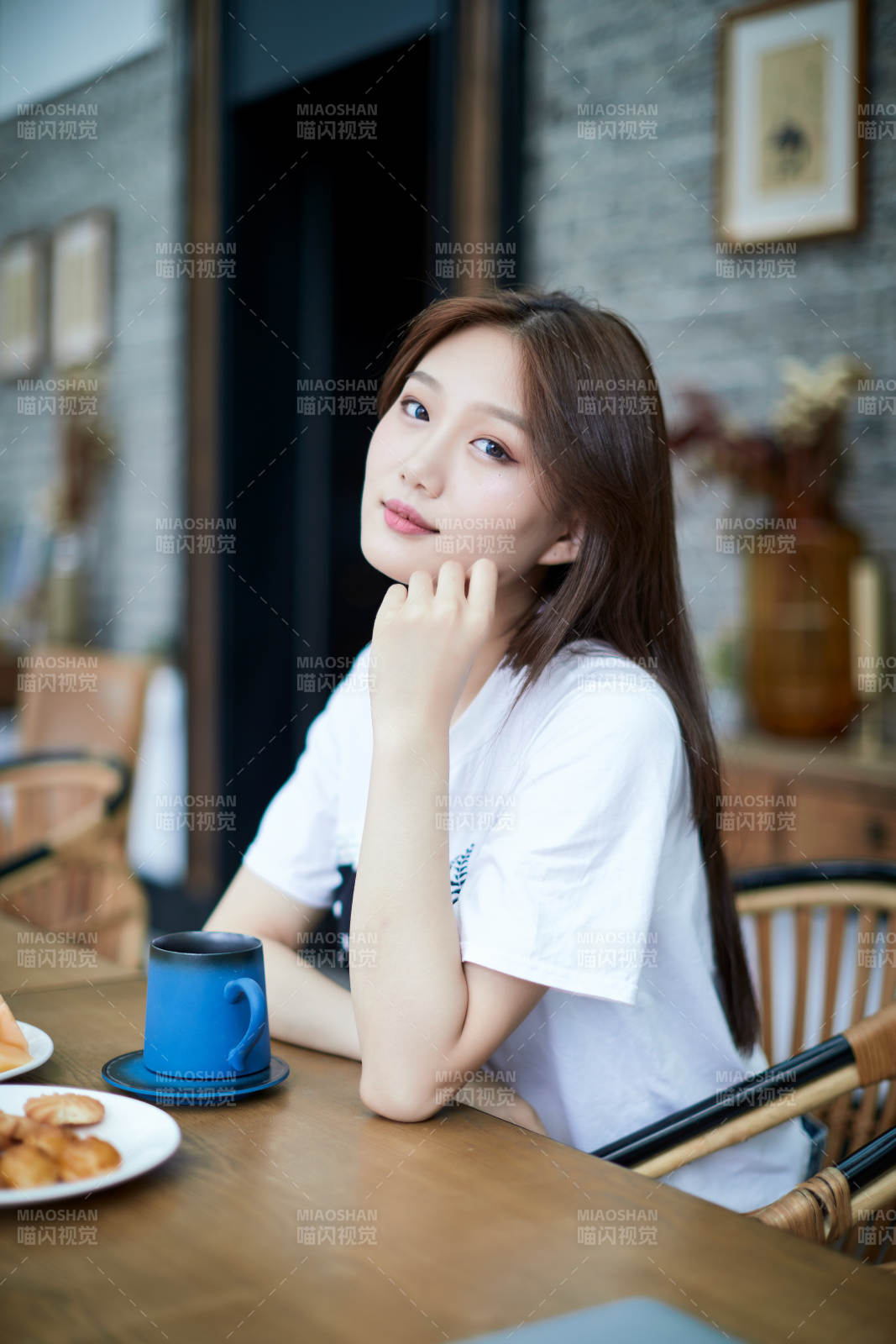 坐在咖啡图书馆吃东西的可爱少女