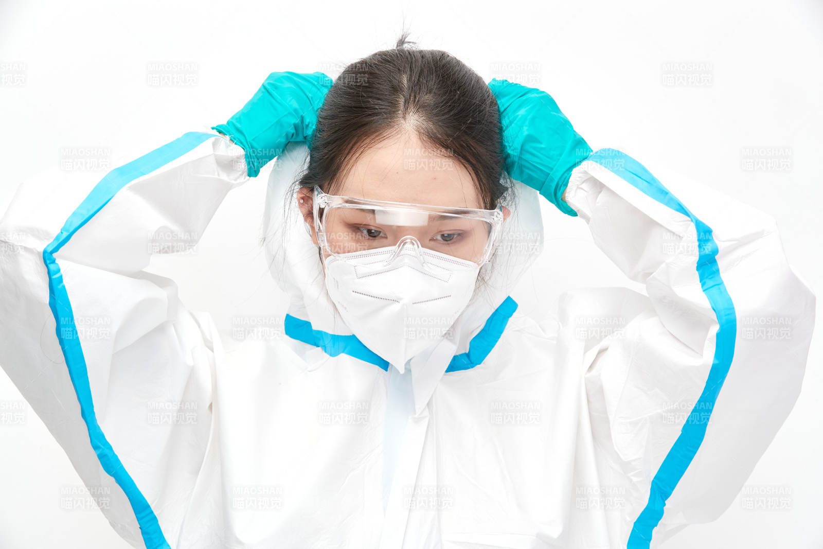 穿白色防护服佩戴护目镜口罩的女性医疗人员