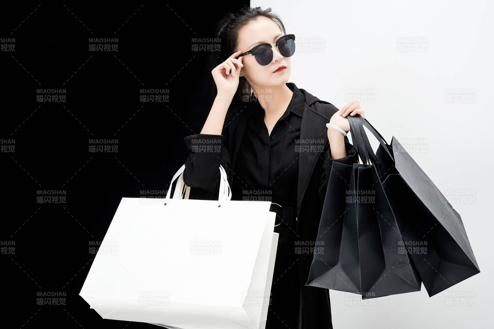 黑白色背景下的手提購物袋的時尚亞洲少女