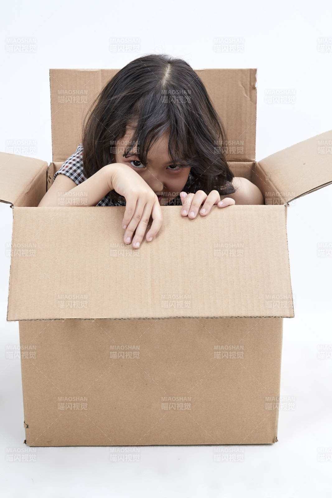 躲在紙箱中玩耍的調皮可愛亞洲小女孩兒童