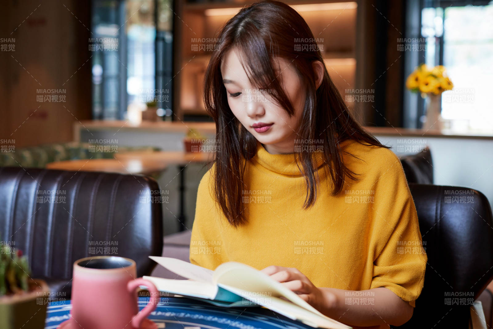 在圖書咖啡館閱讀書籍的少女