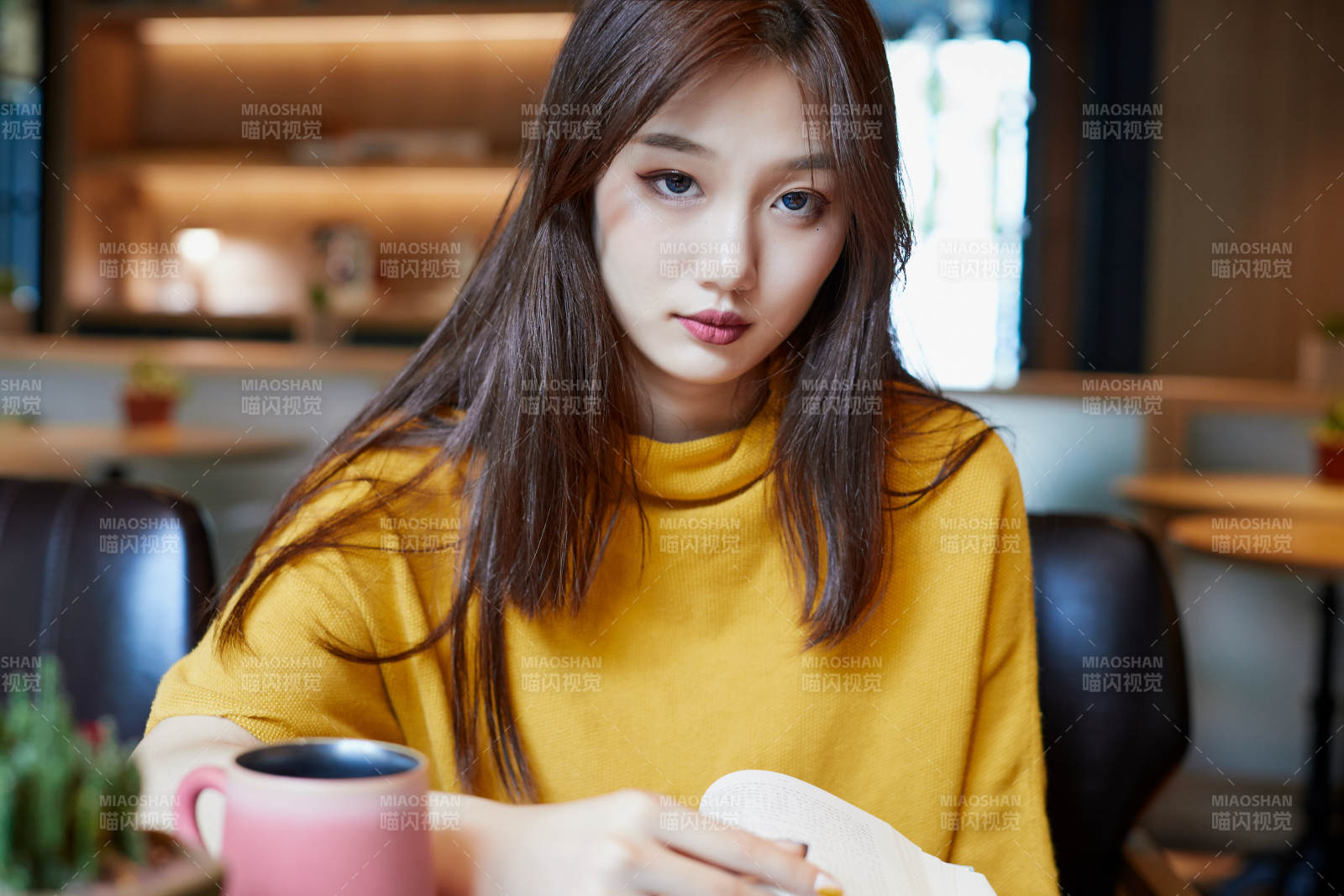 在圖書咖啡館閱讀書籍的少女