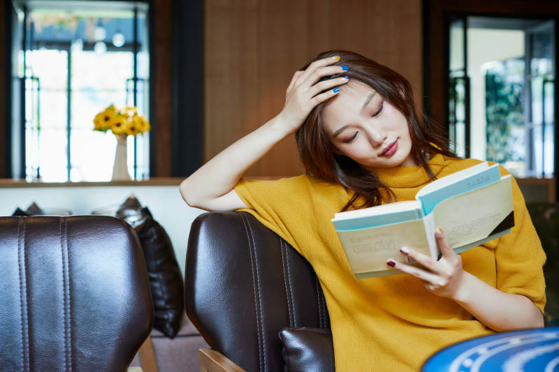 在图书咖啡馆阅读书籍的少女