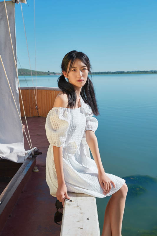 在湖畔木制帆船上的亚洲美女