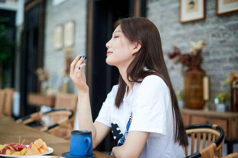 坐在咖啡图书馆吃东西的可爱少女