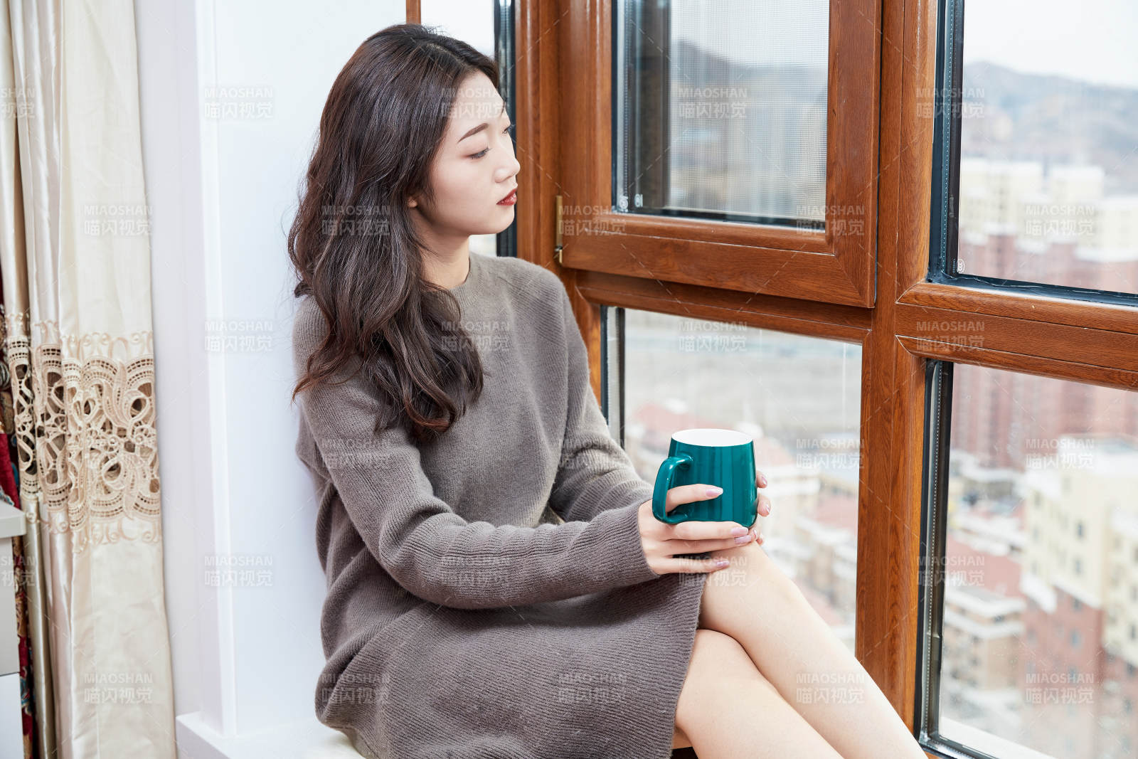 躺在舒适的飘窗上喝咖啡的少女