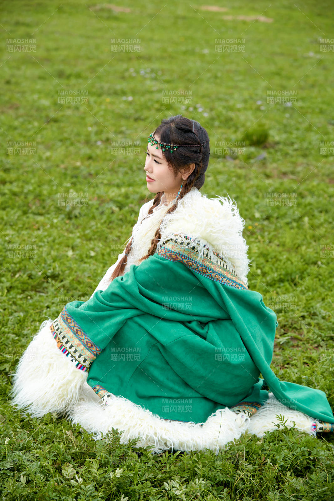 身穿绿色藏族服饰在草原跳舞的美女