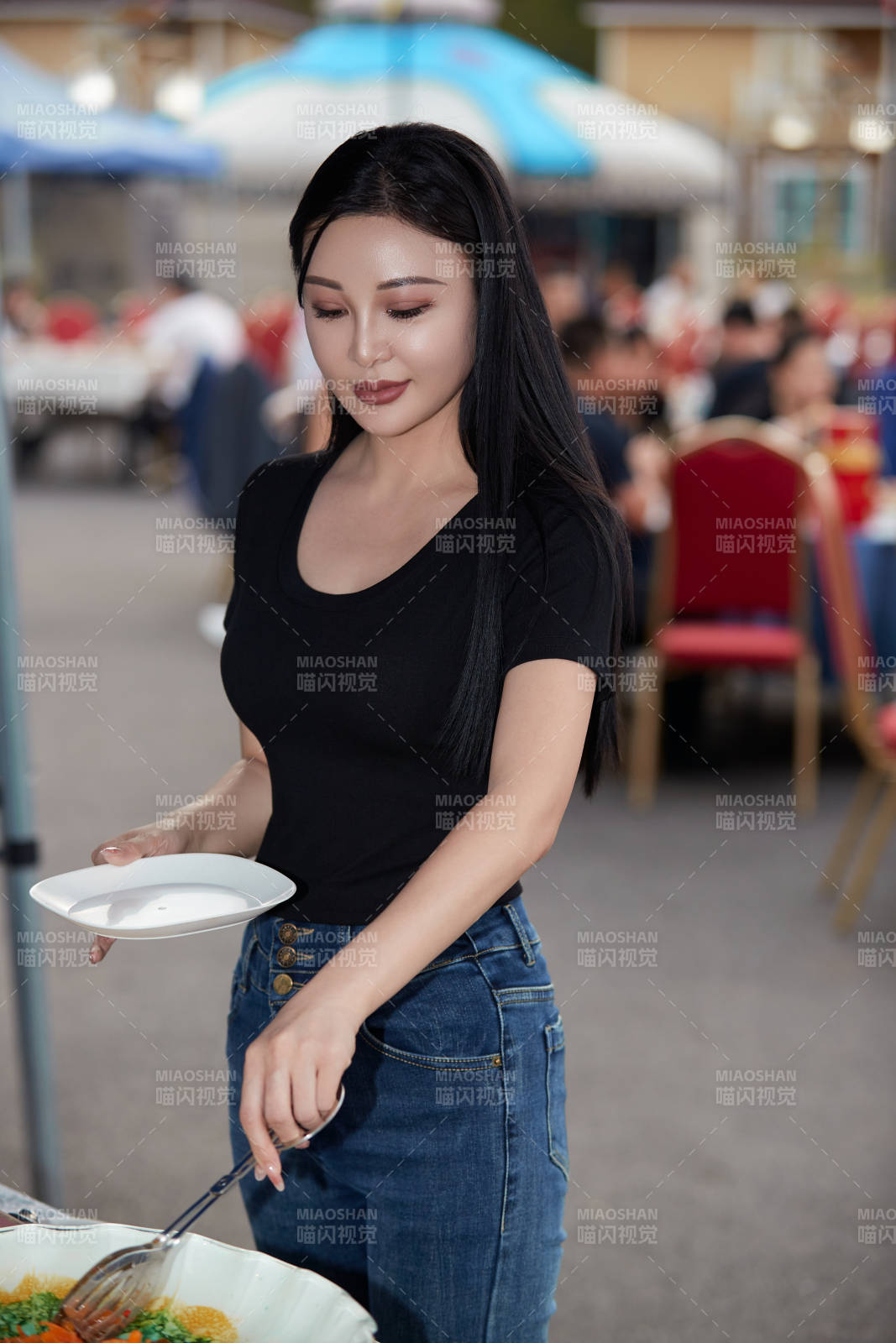 在户外烤全羊自助餐会品尝美食的美女