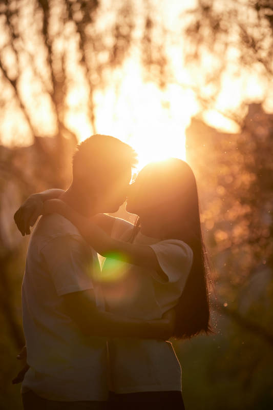 户外在夕阳下的恩爱年轻情侣