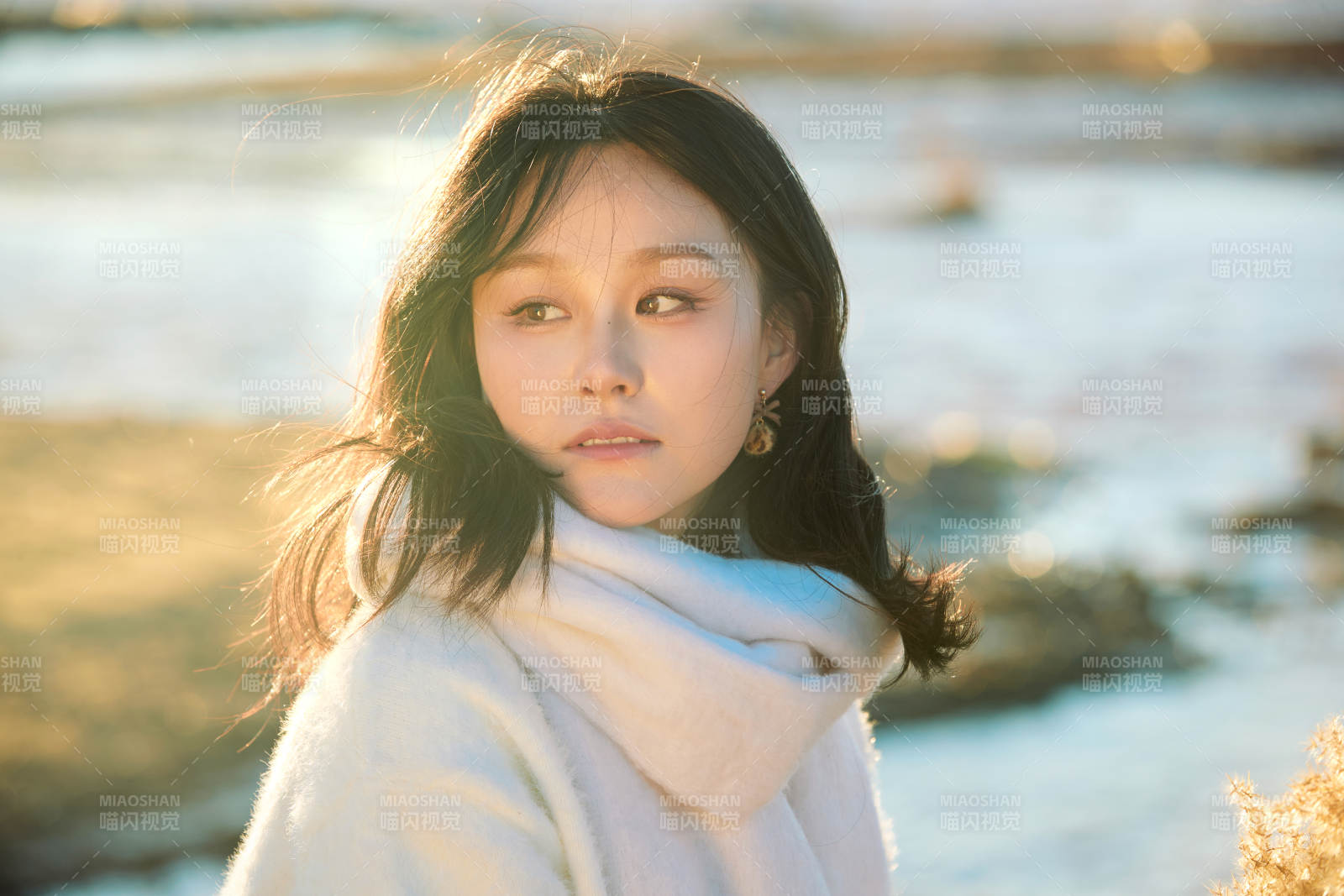 秋天在夕阳下的原野河边拍照的美女