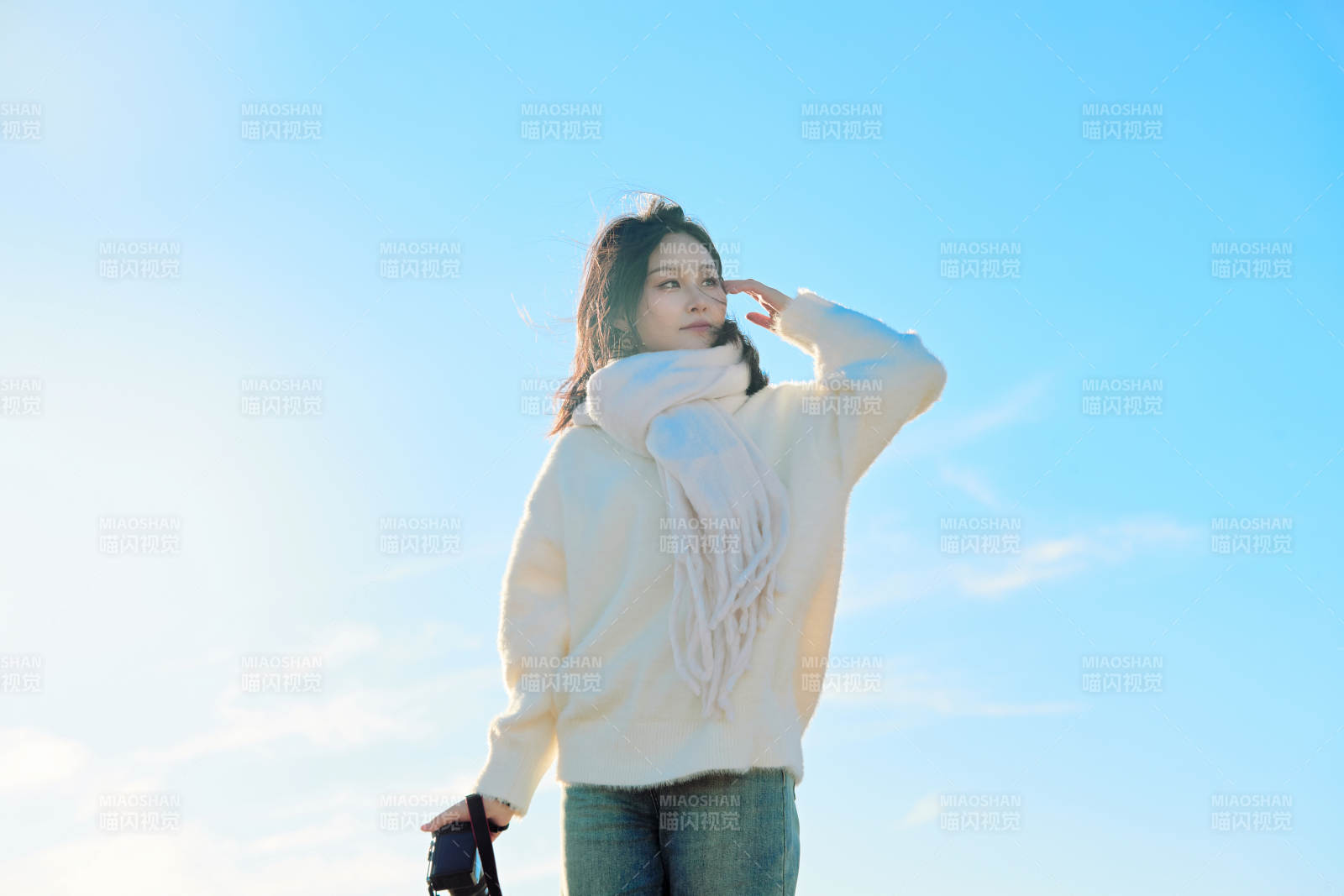 拿着相机的美女摄影师在深秋的户外拍摄