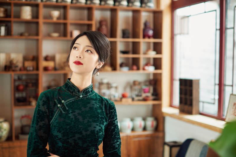 在中式茶社内穿着复古旗袍的中国女性