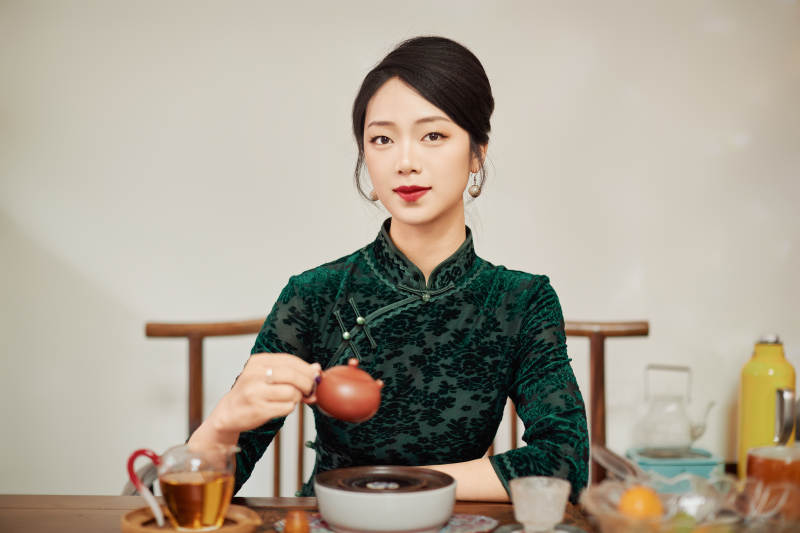 穿着旗袍展示茶道文化的亚洲美女