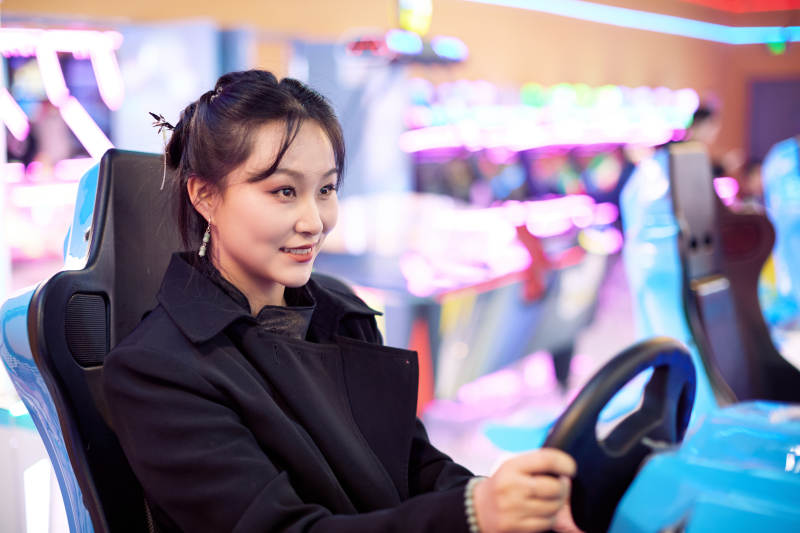 周末在電子游戲娛樂(lè)玩賽車游戲的美女