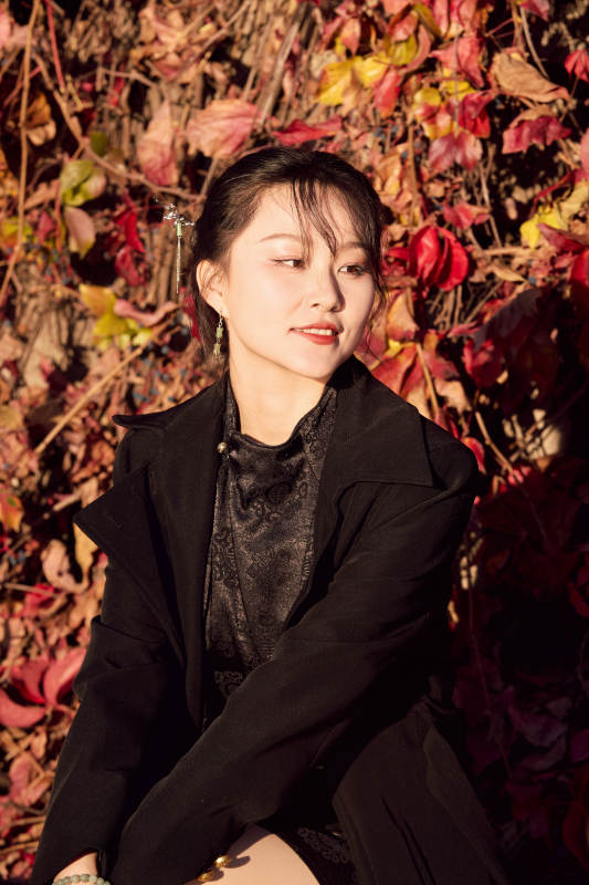 秋天在红叶遍布的河边拍照的亚洲女性