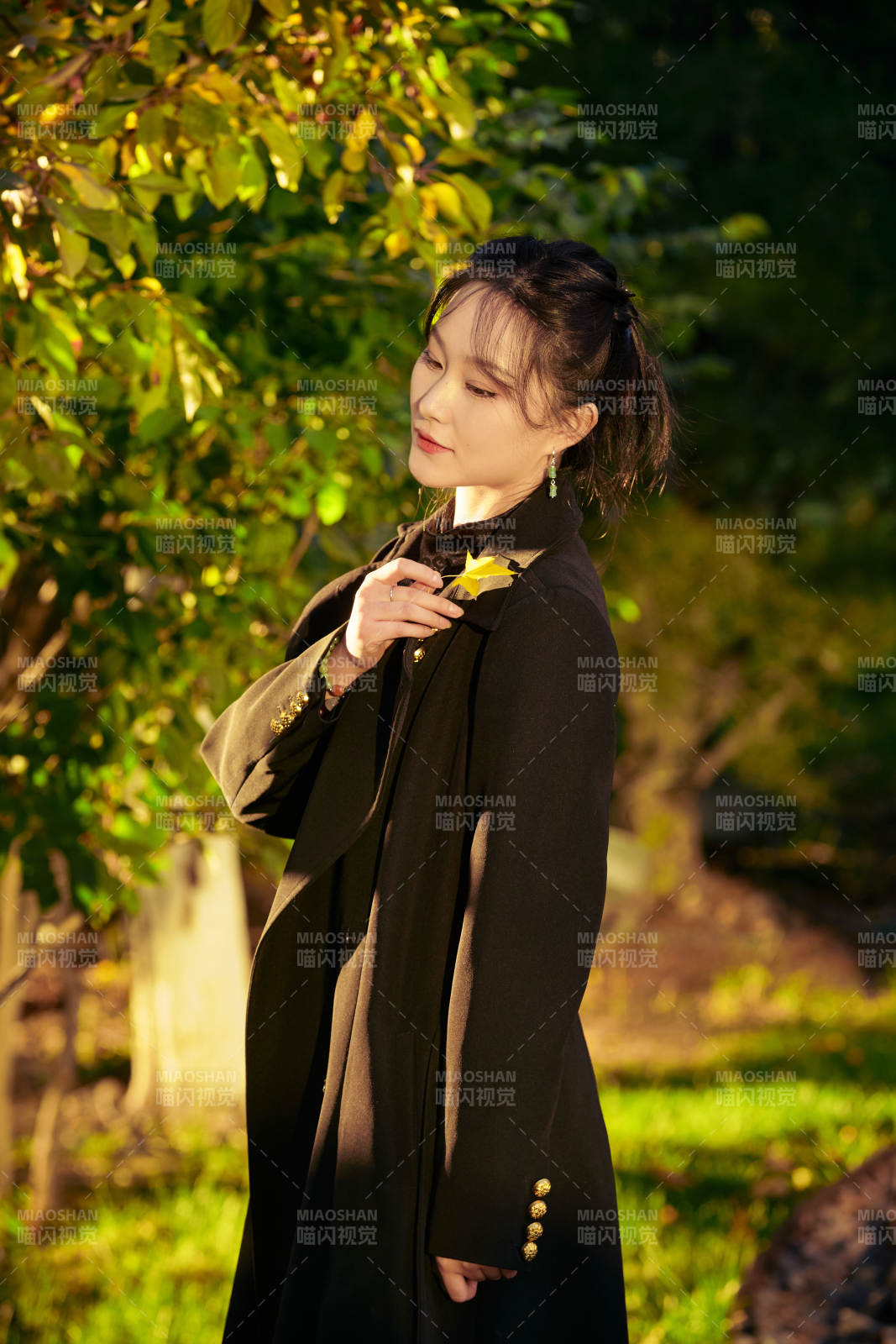 阳光明媚的午后在公园树林拍照的美女