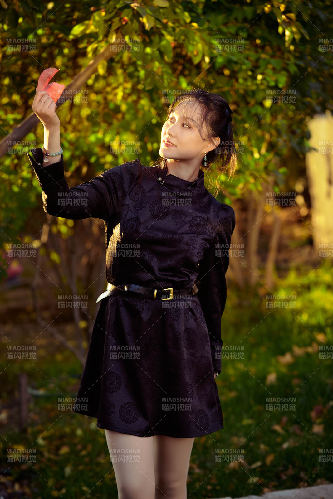 阳光明媚的午后在公园树林拍照的美女