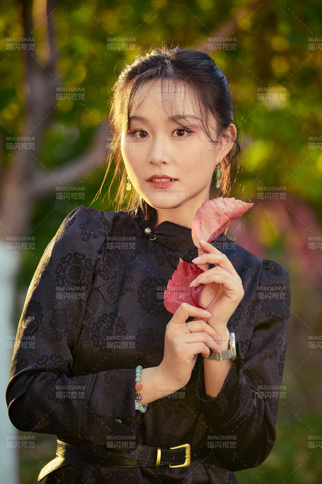 阳光明媚的午后在公园树林拍照的美女