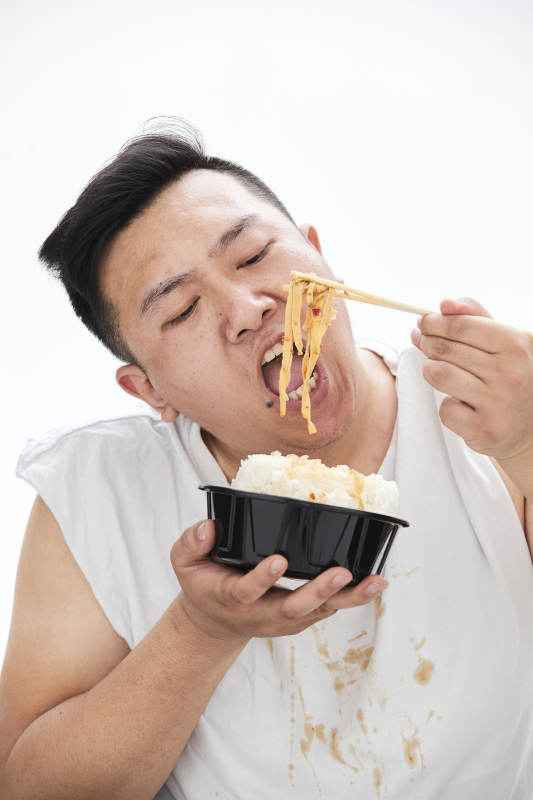 大吃特吃各种食物的肥胖亚洲男子