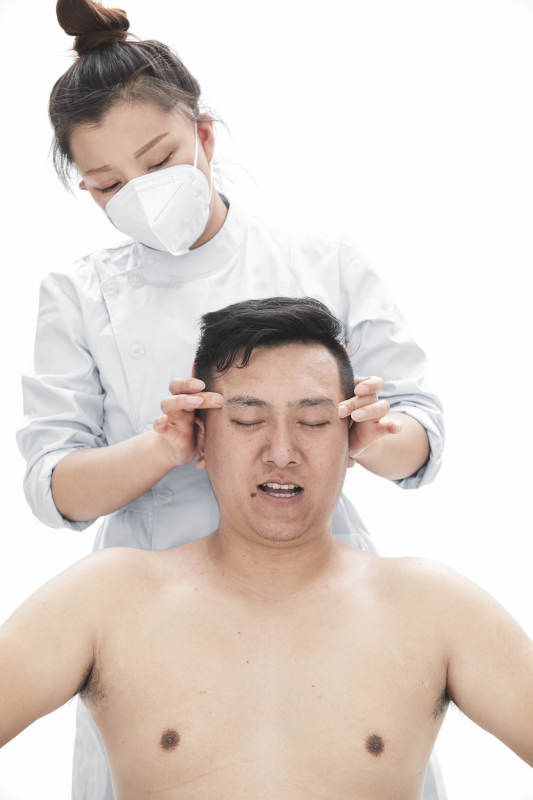 专业按摩师为男子进行身体按摩