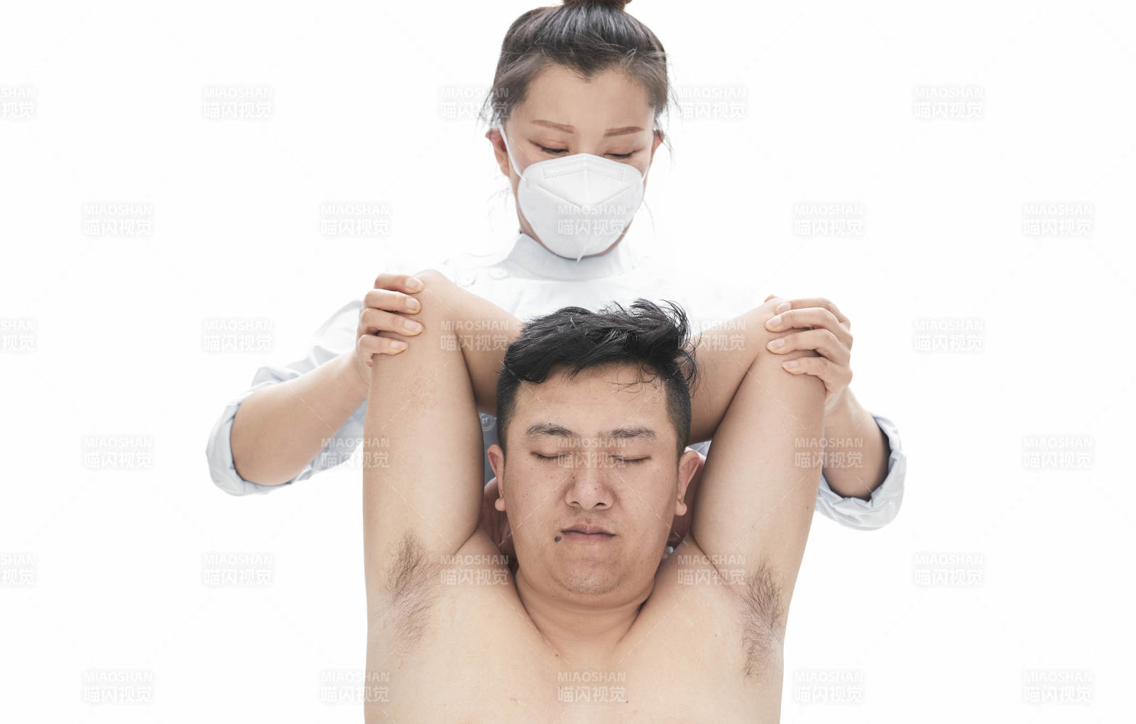 专业按摩师为男子进行身体按摩