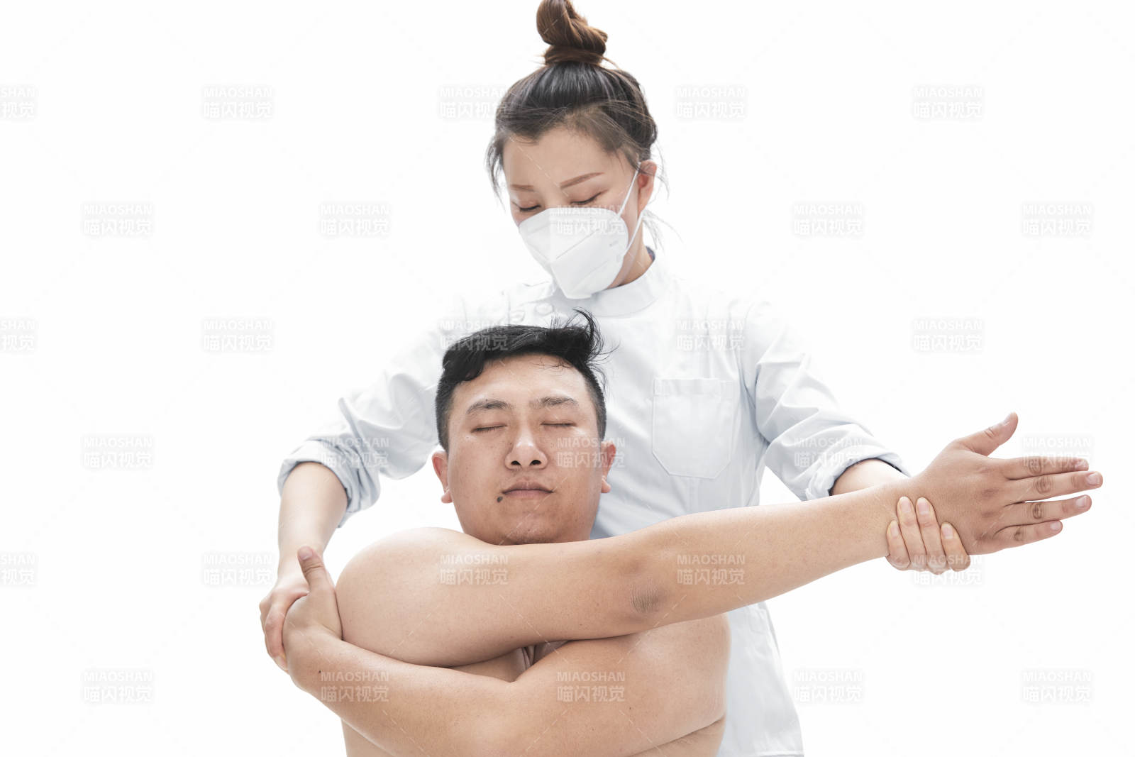 专业按摩师为男子进行身体按摩