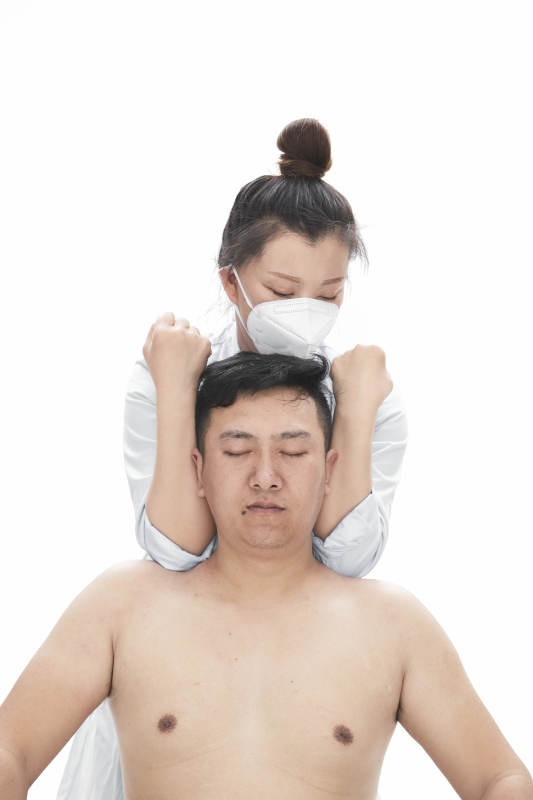 专业按摩师为男子进行身体按摩