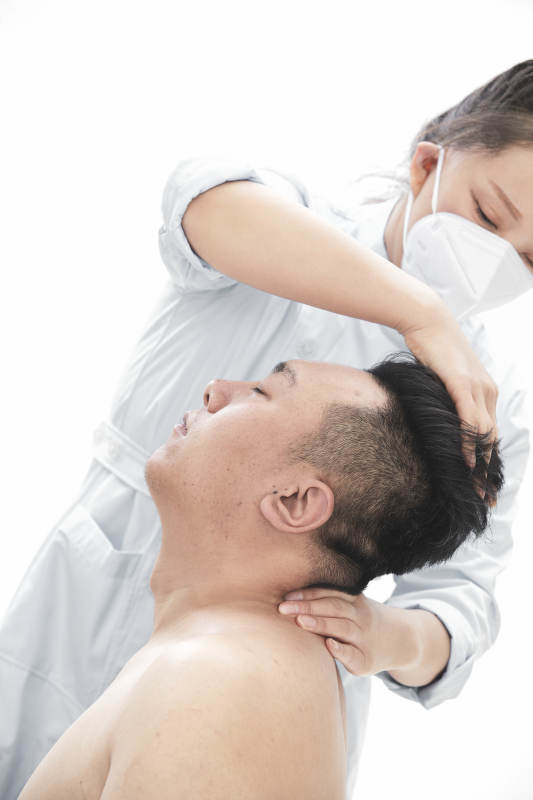 专业按摩师为男子进行身体按摩