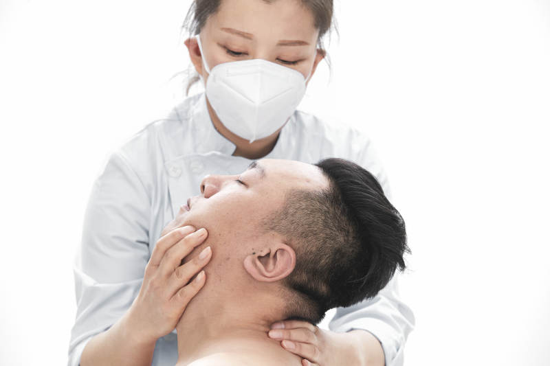 专业按摩师为男子进行身体按摩