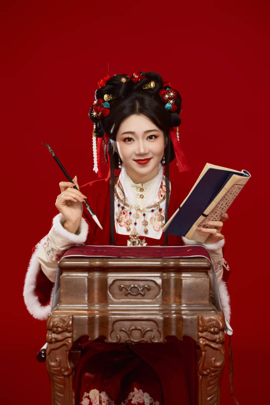 红色背景下身穿喜庆汉服认真学习的中国美女
