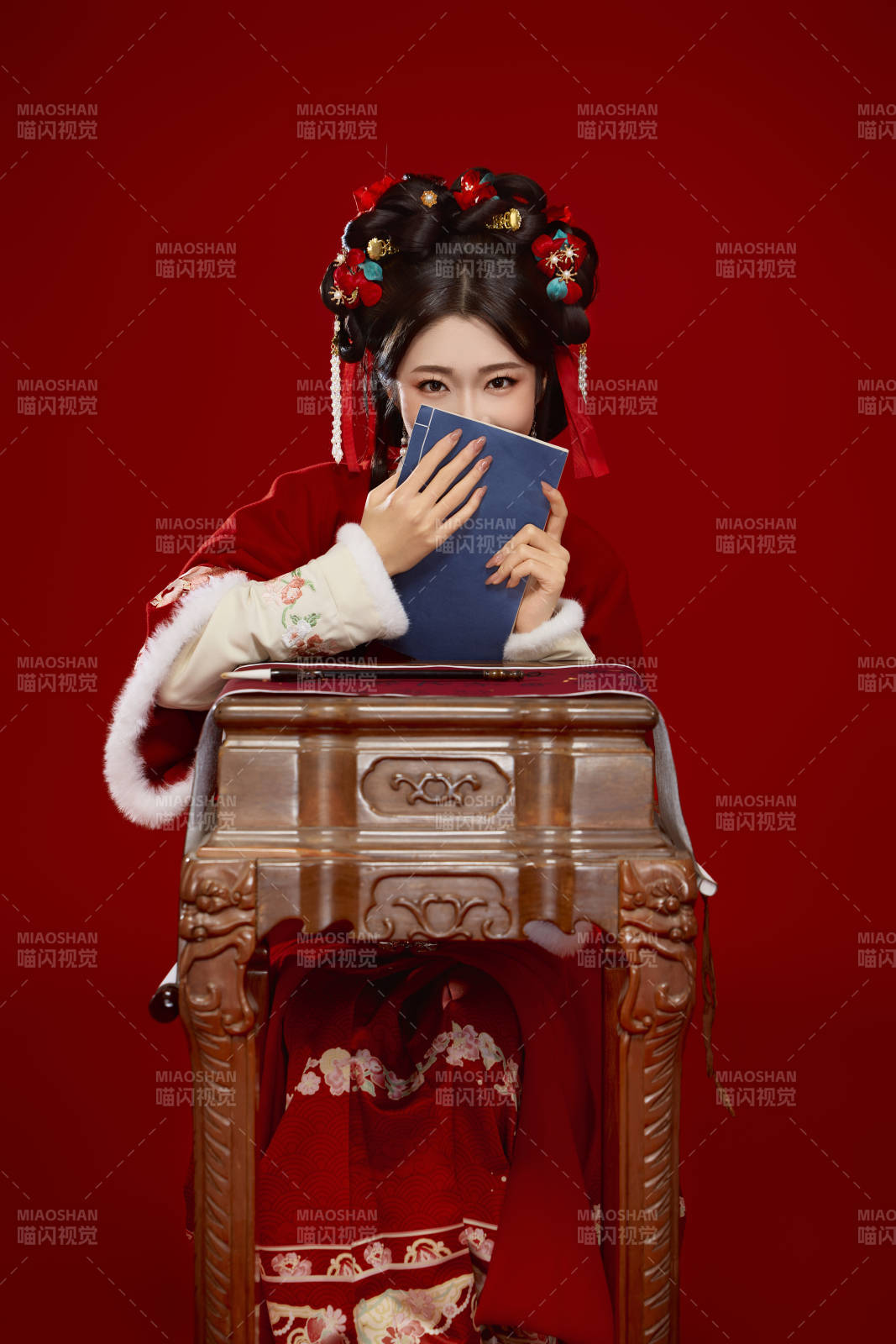 红色背景下身穿喜庆汉服认真学习的中国美女