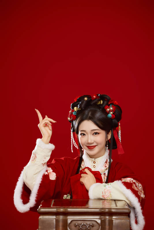 喜庆红色背景下身穿中国汉服的年轻女性