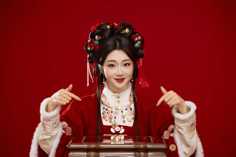 喜庆红色背景下身穿中国汉服的年轻女性