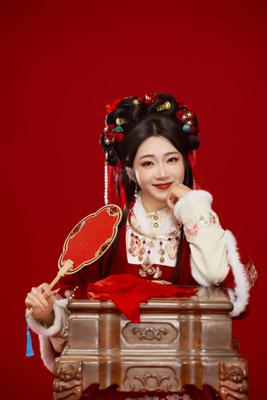 喜庆红色背景下身穿中国汉服的年轻女性