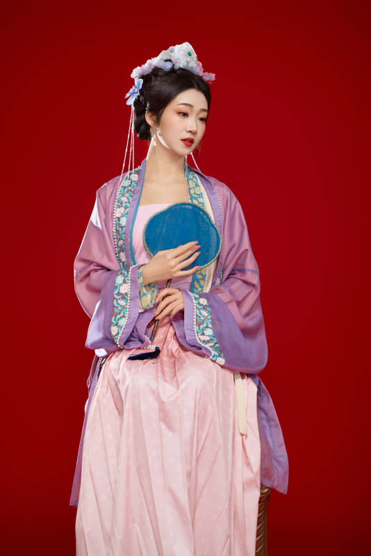 红色背景下身穿中国明朝簪花发饰汉服的美女