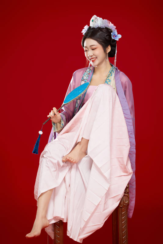 红色背景下身穿中国明朝簪花发饰汉服的美女