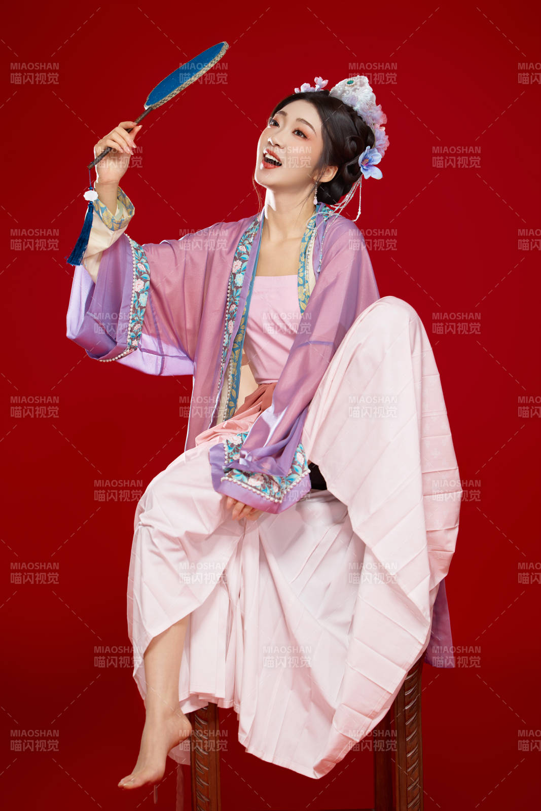 红色背景下身穿中国明朝簪花发饰汉服的美女