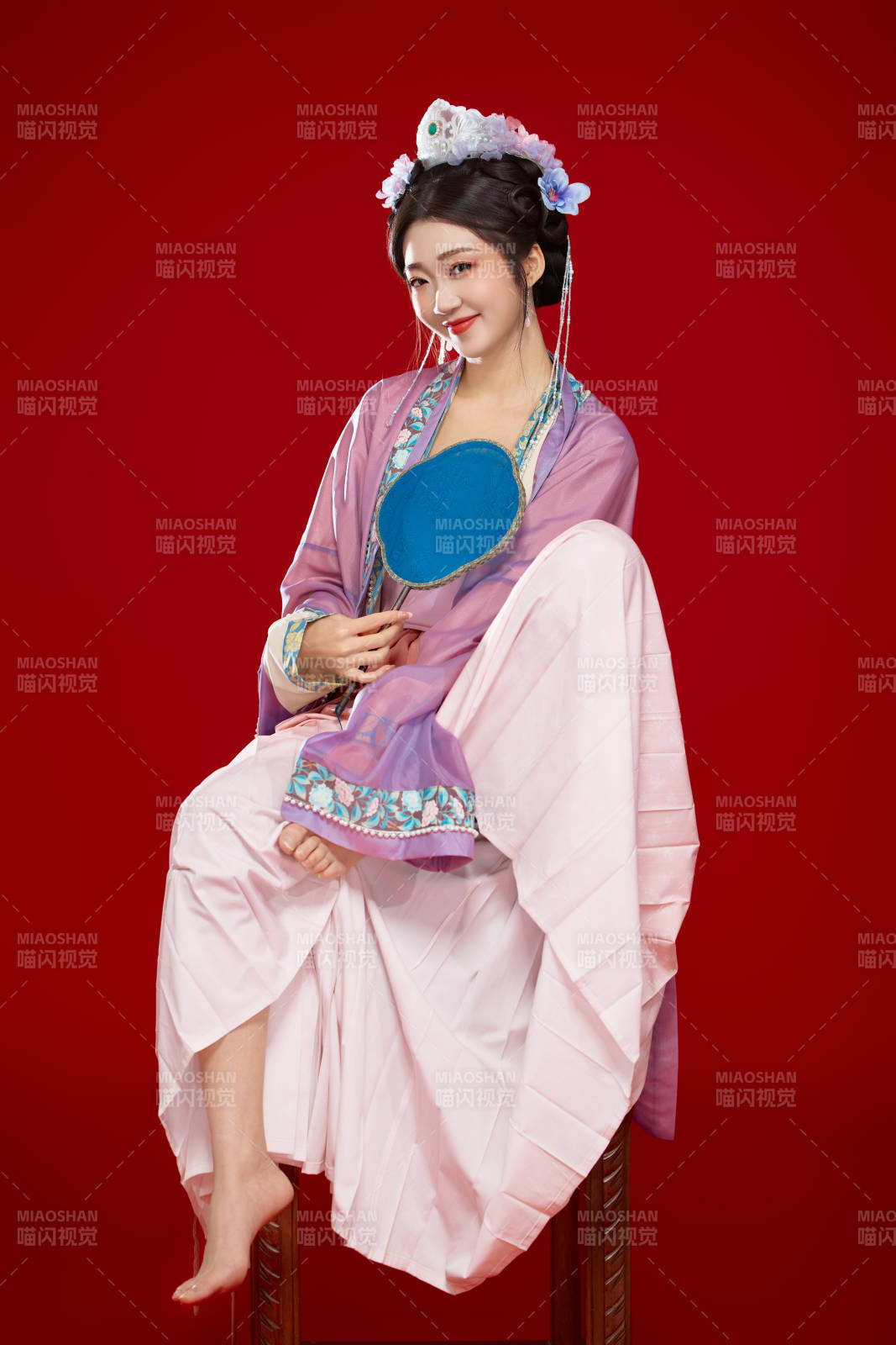 红色背景下身穿中国明朝簪花发饰汉服的美女