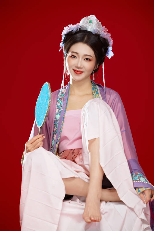 红色背景下身穿中国明朝簪花发饰汉服的美女