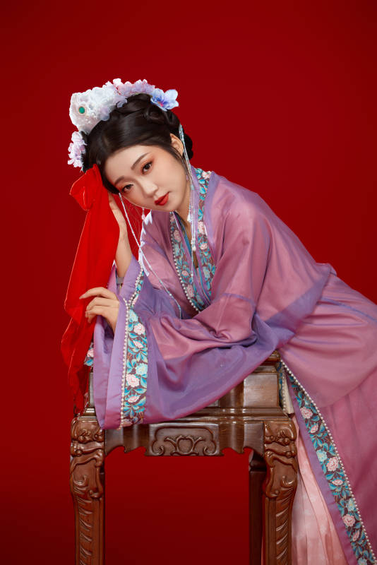 紅色背景下身穿中國明朝簪花發(fā)飾漢服的美女