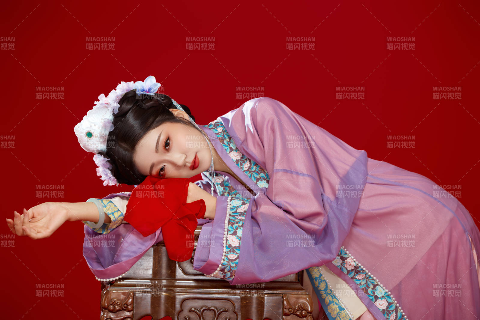 红色背景下身穿中国明朝簪花发饰汉服的美女图片