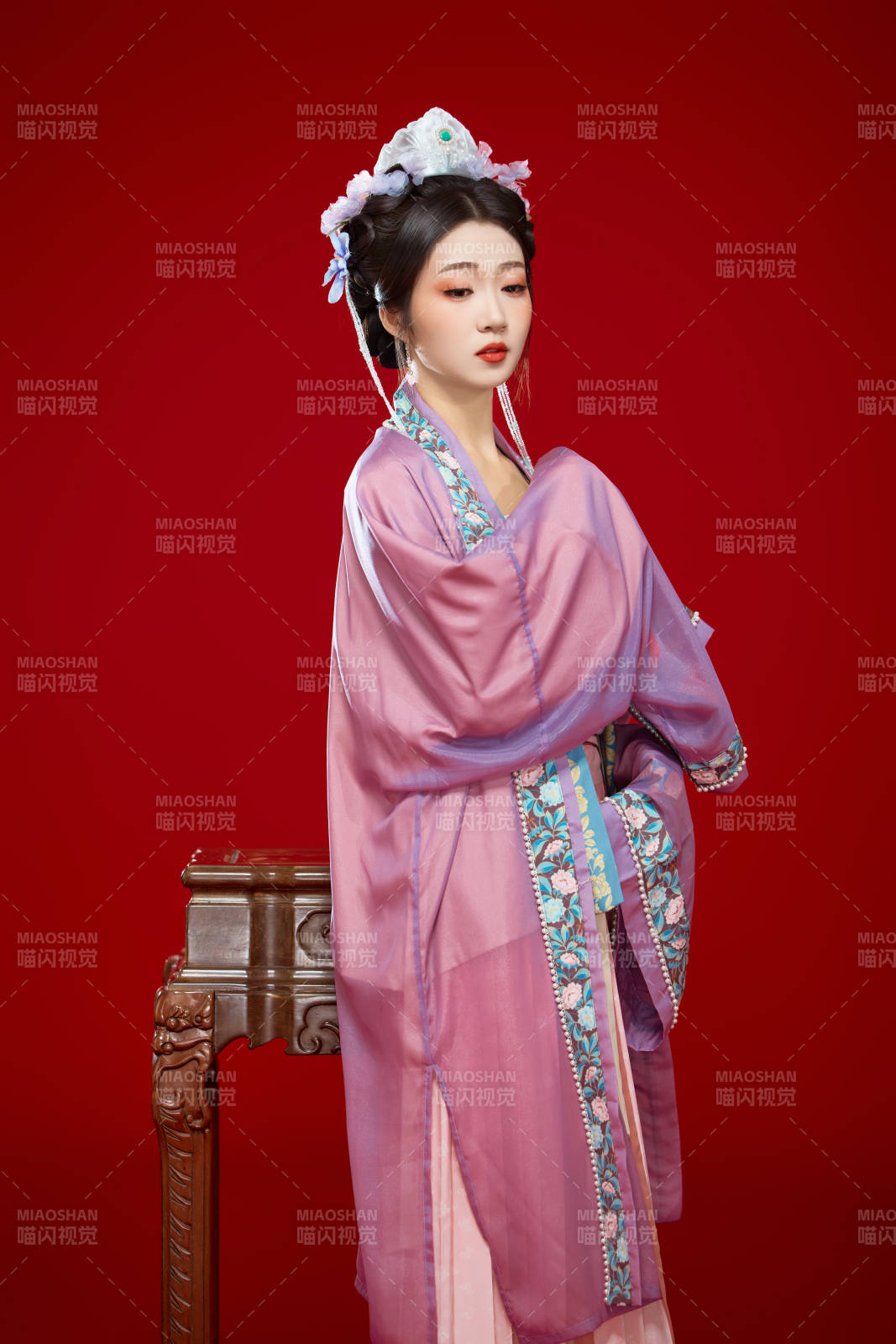 红色背景下身穿中国明朝簪花发饰汉服的美女