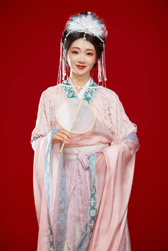 红色背景下身穿中国明朝簪花发饰汉服的美女