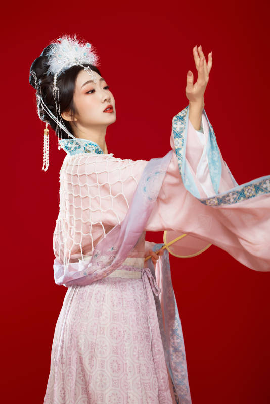 红色背景下身穿中国明朝簪花发饰汉服的美女