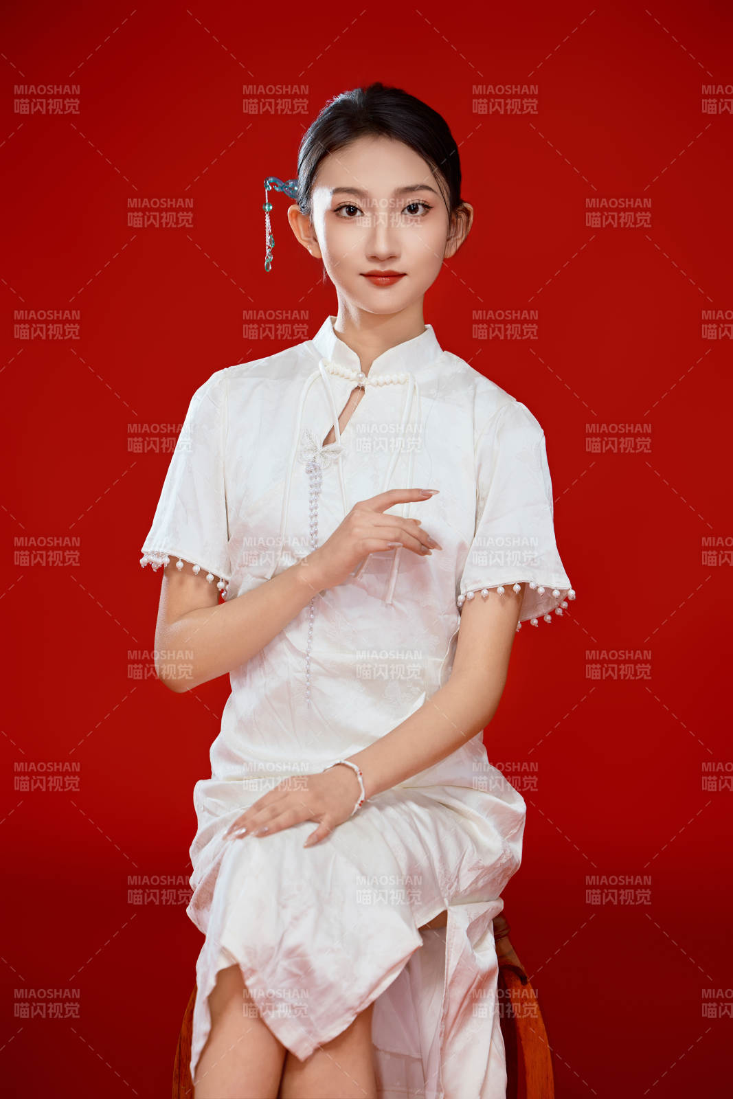 紅色背景下穿著中式傳統旗袍的美麗少女-攝影圖