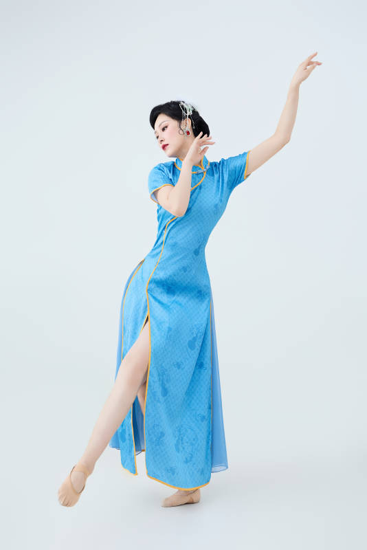 穿着中国中式旗袍表演舞蹈的美丽舞者