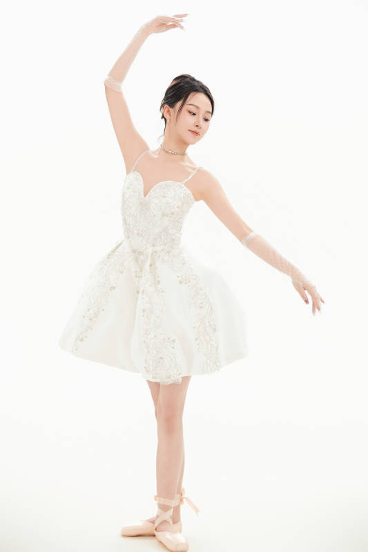 白色背景下跳芭蕾舞的亚洲少女