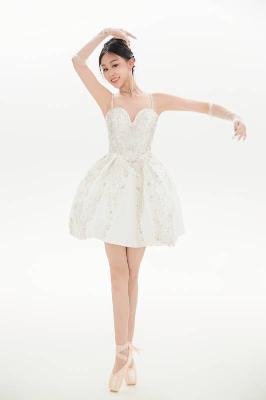 白色背景下跳芭蕾舞的亚洲少女