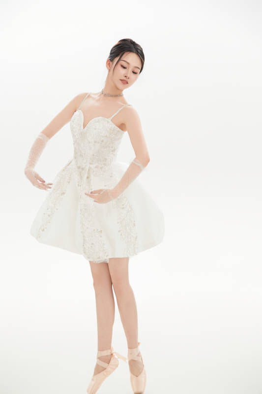 白色背景下跳芭蕾舞的亚洲少女